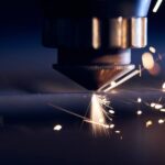 Close-up of a laser cutting machine cutting through a metal sheet with high precision.